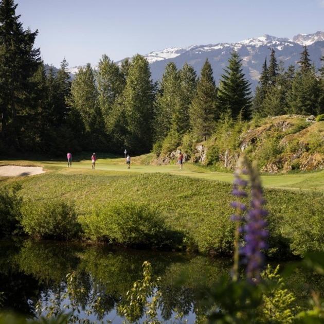 Forest‑framed fairway with mountain views in Whistler.