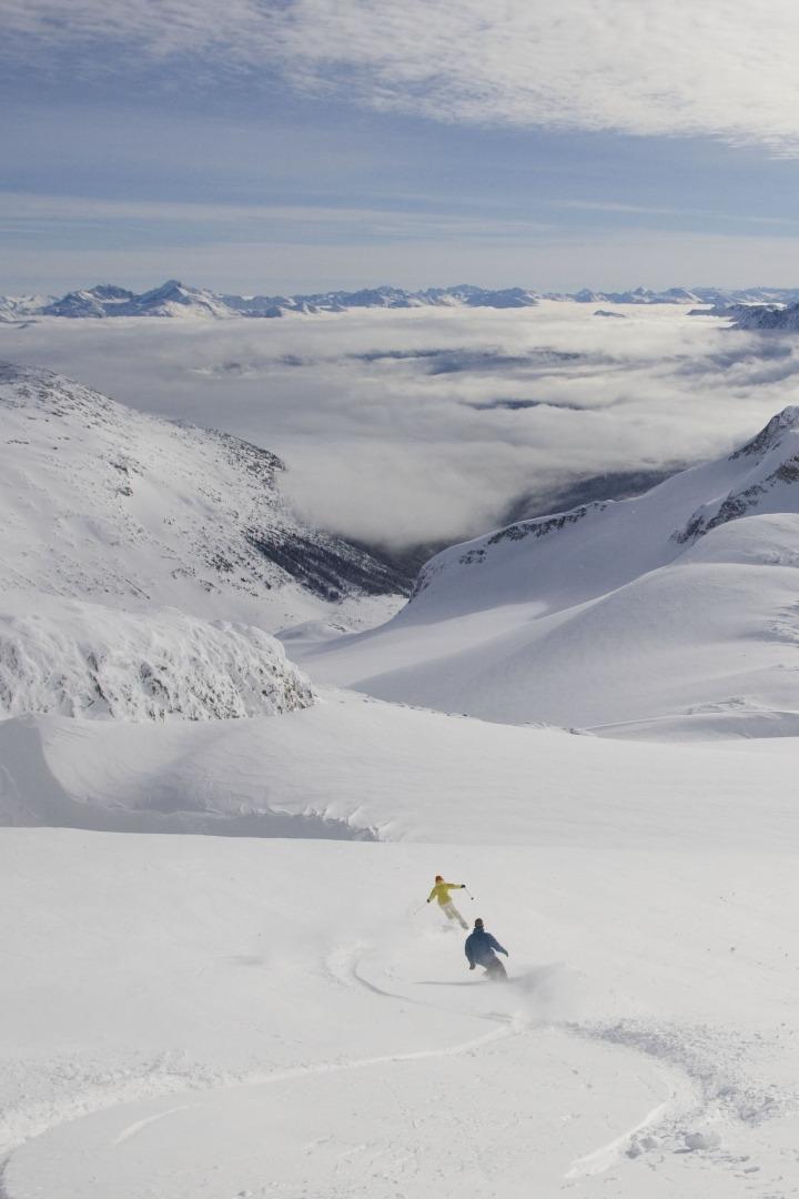 Skier drops first tracks from a heli above Whistler’s alpine.