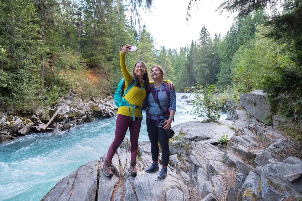 two women hiking along the Cheakamus River in Whistler, British Columbia
